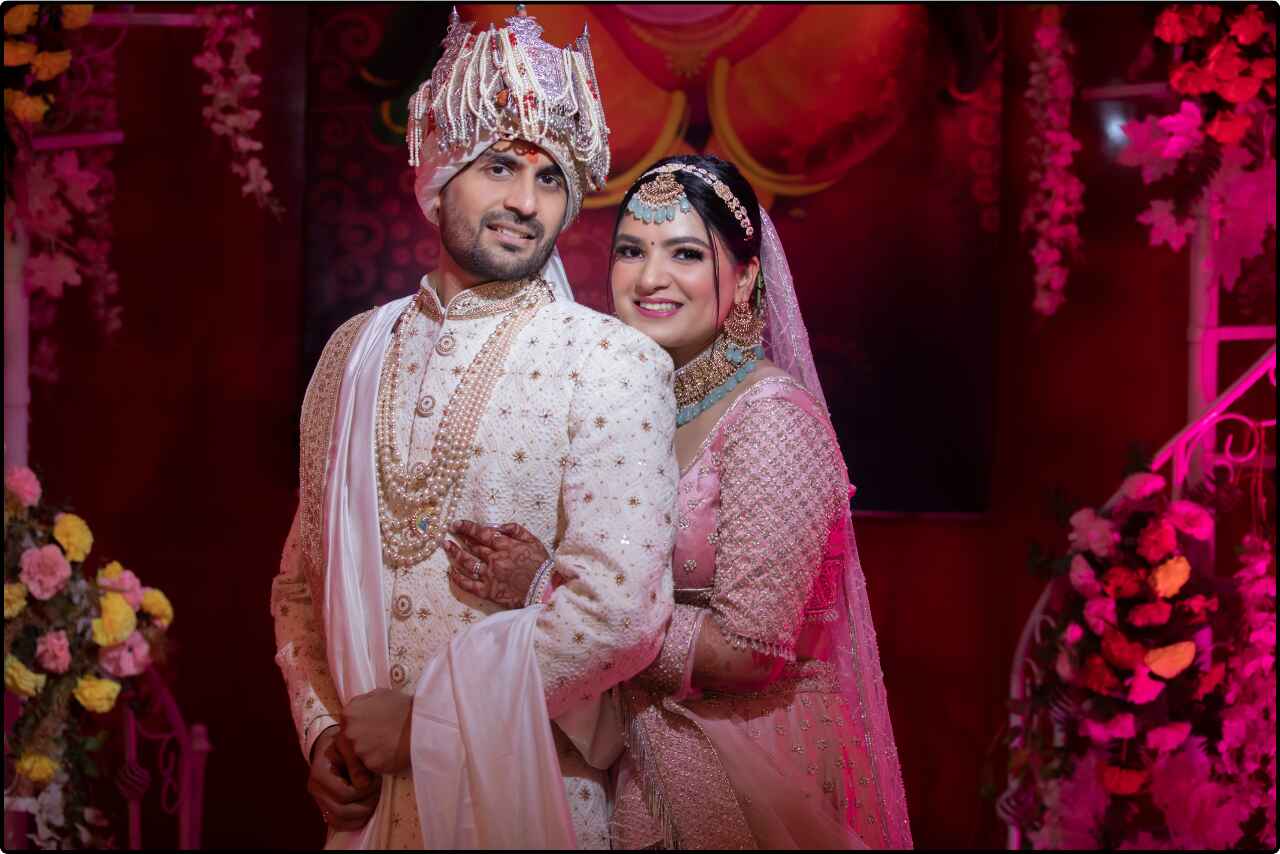 Bride and groom stand closely together, smiling at the camera during their wedding photo session.